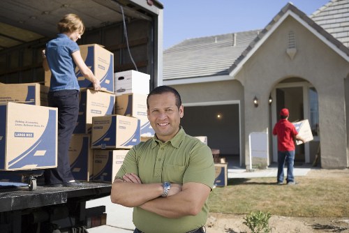 Recycling-focused van loading with furniture and cardboard prepared for transfer stations