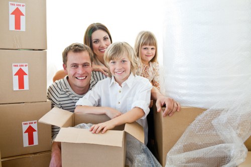 Local movers handling desks and equipment in a Wapping office
