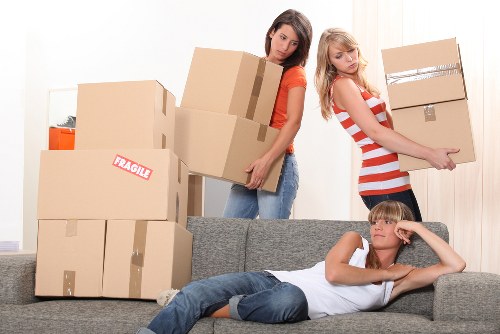 Moving team preparing boxes and furniture for transport in Wapping