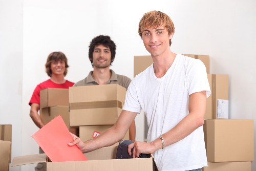 Packed moving boxes and household items ready for collection in Wapping