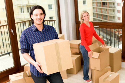 Professional movers handling household items in East London