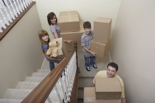 Professional movers navigating apartment building access during a Wapping house move